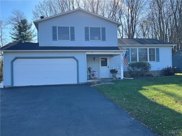 view of front of property with a front yard and a garage