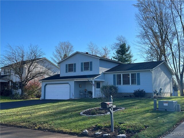 view of front of home with a garage and a front lawn