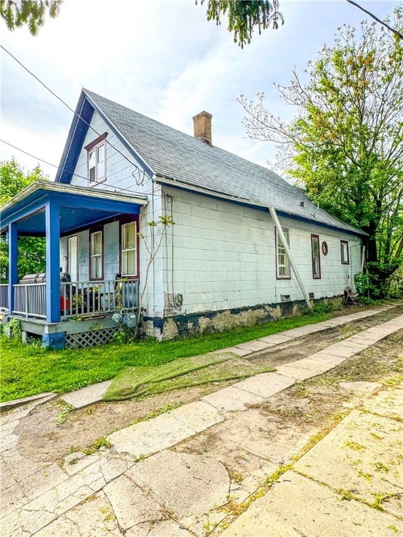 view of property exterior featuring a porch