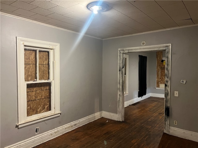 unfurnished room featuring dark hardwood / wood-style floors and ornamental molding