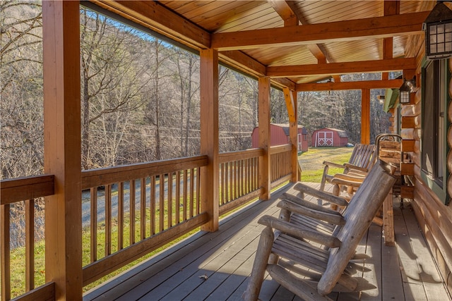 wooden terrace with a shed