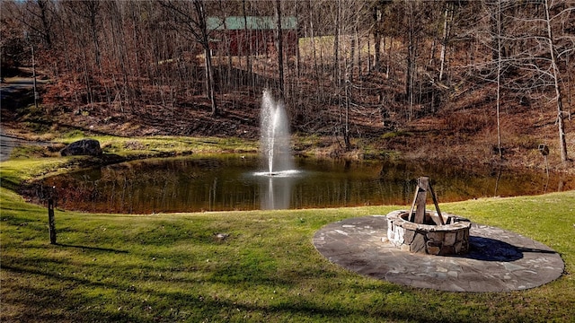 view of community with a yard and a water view