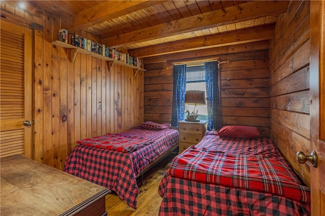 bedroom featuring hardwood / wood-style flooring, wood walls, wooden ceiling, and beamed ceiling