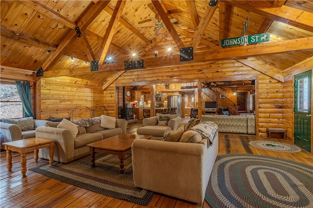 living room with rustic walls, wooden ceiling, beamed ceiling, and wood-type flooring