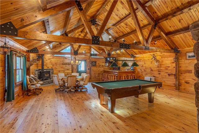 recreation room with a wood stove, wooden ceiling, billiards, wooden walls, and light wood-type flooring