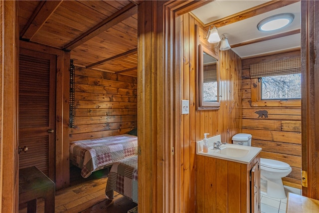 bathroom with hardwood / wood-style floors, vanity, wood ceiling, and toilet