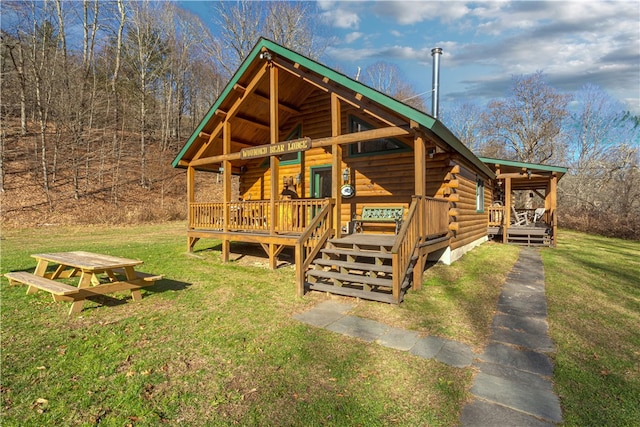 view of front of home featuring a front yard and a deck