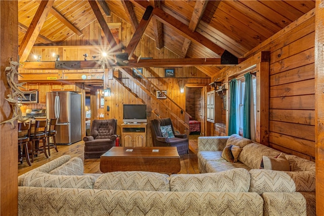 living room featuring beam ceiling, high vaulted ceiling, wood-type flooring, wooden walls, and wood ceiling