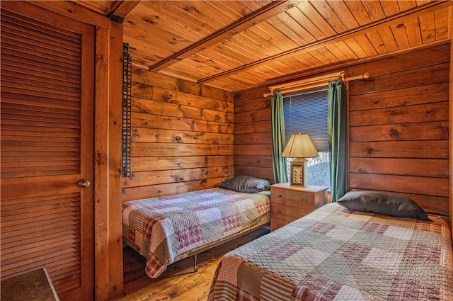 bedroom with wood-type flooring, wooden walls, and wooden ceiling