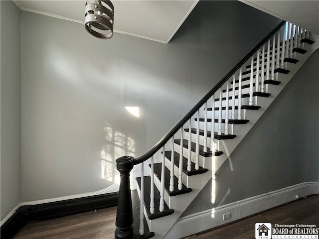 stairway featuring hardwood / wood-style floors and ornamental molding