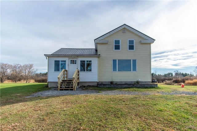 back of house with a lawn