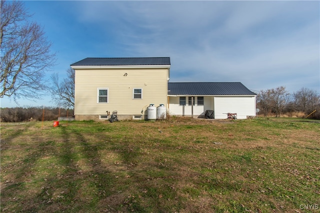 rear view of property with a lawn