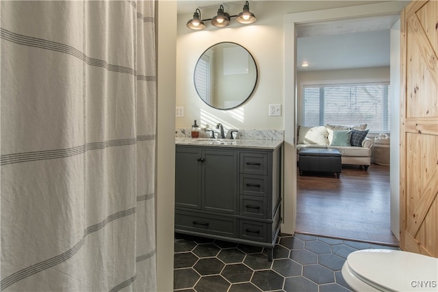 bathroom featuring tile patterned flooring, vanity, and toilet