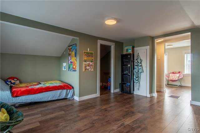 bedroom featuring vaulted ceiling and dark hardwood / wood-style floors