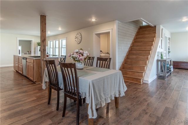 dining room with dark hardwood / wood-style floors and built in shelves