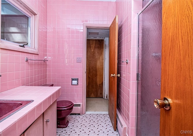 bathroom featuring toilet, tile walls, a baseboard radiator, and walk in shower