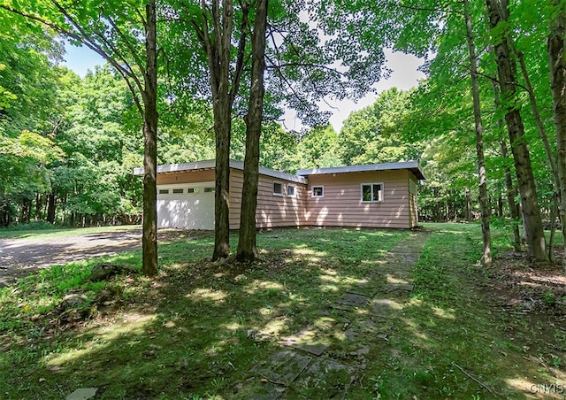 exterior space with a lawn and a garage