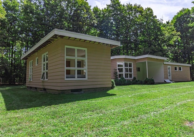 view of property exterior featuring a lawn