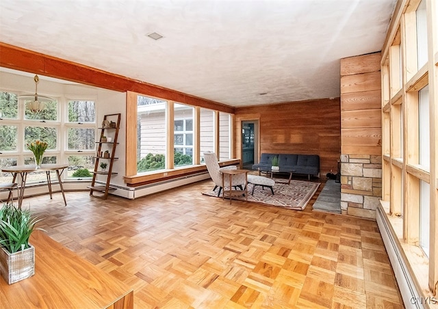 sunroom / solarium featuring a baseboard radiator