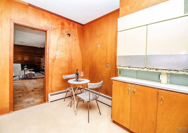 interior space with light parquet floors, crown molding, and wood walls