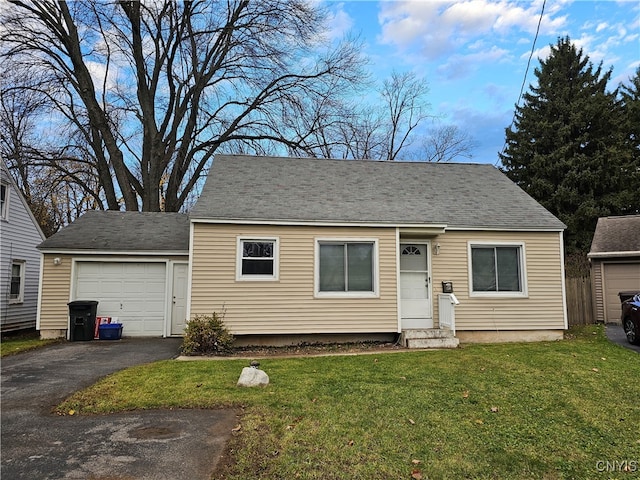 view of front of house featuring a garage and a front lawn