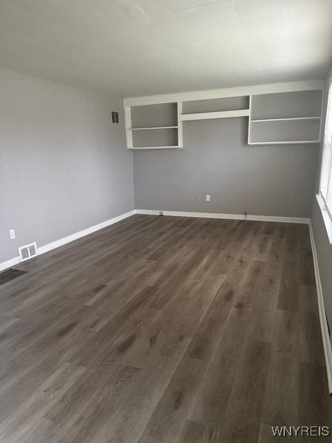 spare room featuring dark hardwood / wood-style floors