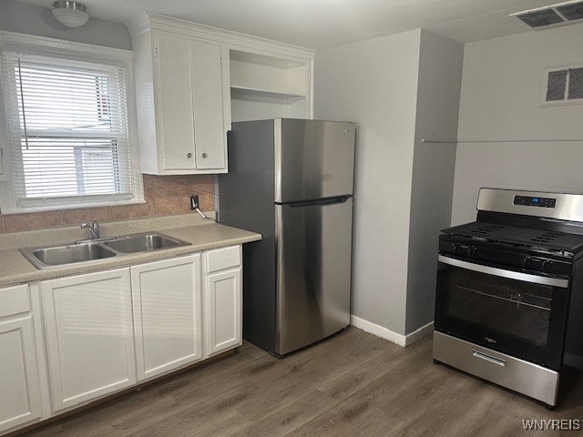 kitchen with white cabinetry, sink, dark wood-type flooring, and appliances with stainless steel finishes