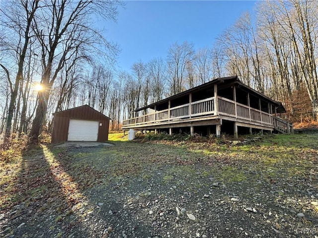 view of side of home featuring a garage and an outdoor structure