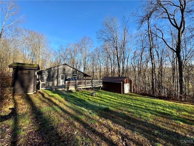 view of yard with a storage unit and a deck