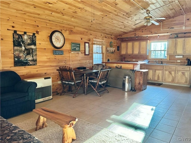 dining room featuring ceiling fan, wood walls, lofted ceiling, light tile patterned flooring, and wood ceiling