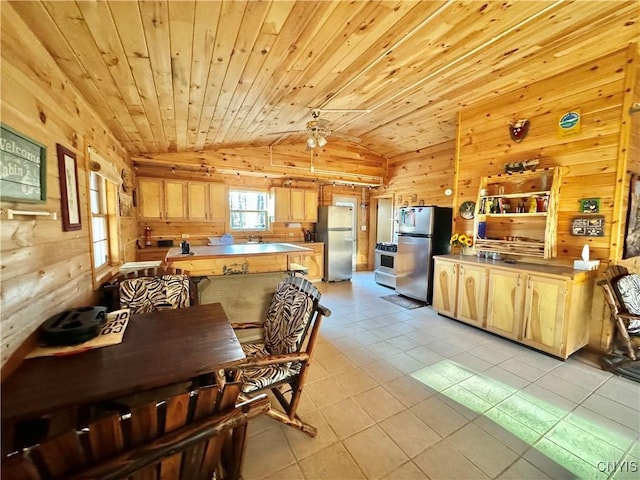 tiled dining room with wooden walls, vaulted ceiling, ceiling fan, and wooden ceiling