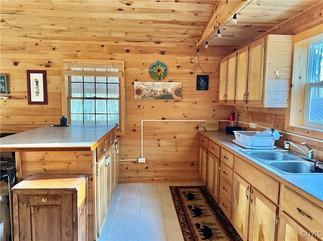 kitchen featuring sink, light brown cabinets, wooden ceiling, a kitchen island, and light tile patterned floors