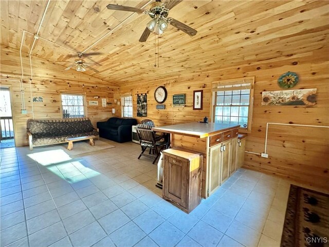 kitchen with a center island, wood ceiling, wooden walls, and vaulted ceiling