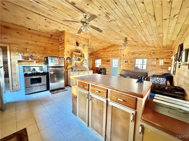 kitchen with decorative light fixtures, stainless steel refrigerator, wood walls, and wood ceiling