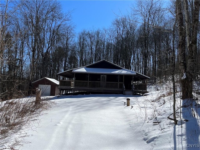 view of front of property with a garage and an outdoor structure