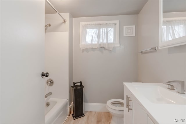 full bathroom with hardwood / wood-style floors, vanity, toilet, and tub / shower combination