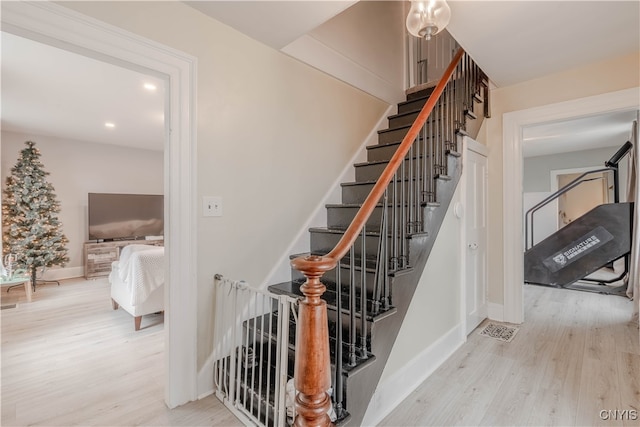 staircase featuring hardwood / wood-style floors