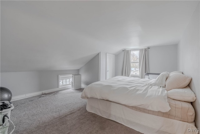 carpeted bedroom featuring multiple windows and lofted ceiling