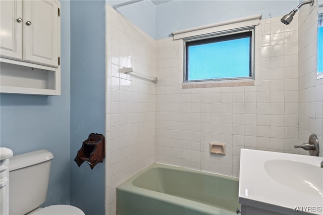 full bathroom with vanity, tiled shower / bath combo, and toilet