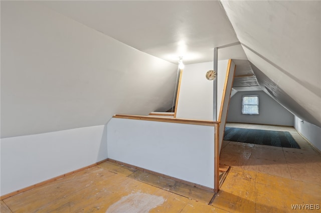 additional living space featuring lofted ceiling