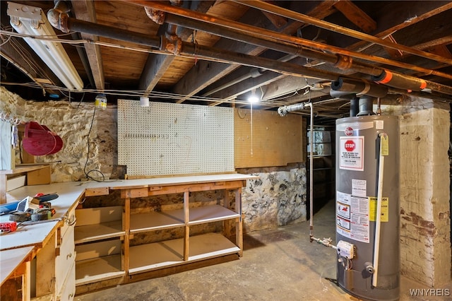 basement with a workshop area and water heater