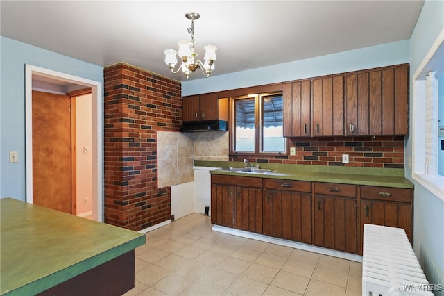 kitchen with tasteful backsplash, dark brown cabinets, decorative light fixtures, and radiator