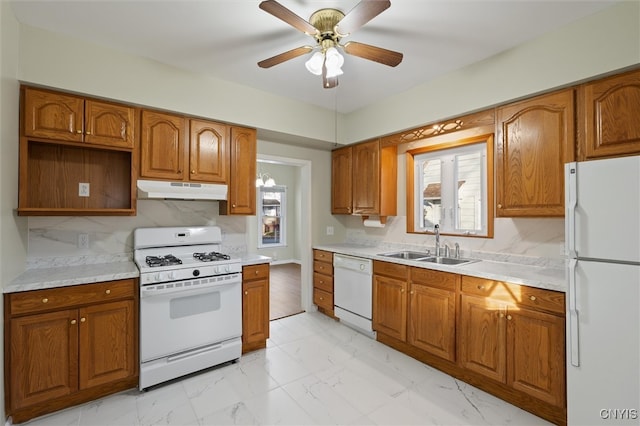 kitchen featuring decorative backsplash, ceiling fan, sink, and white appliances