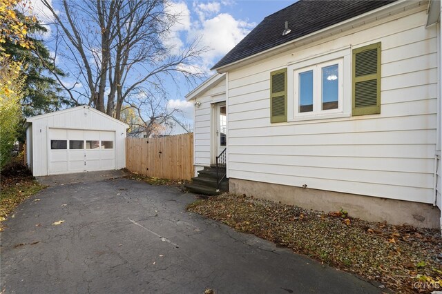 view of side of home with an outdoor structure and a garage