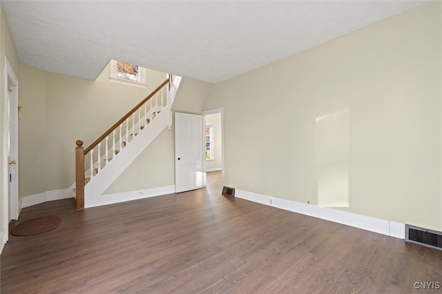 unfurnished living room with a healthy amount of sunlight and hardwood / wood-style flooring