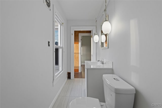 bathroom featuring tile patterned floors, vanity, and toilet