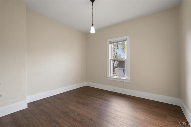 empty room with dark hardwood / wood-style floors