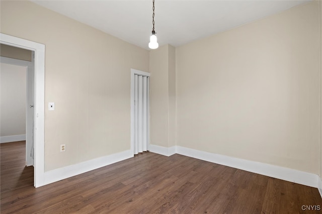 empty room featuring dark hardwood / wood-style flooring