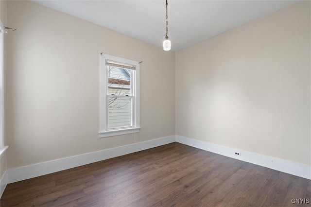 spare room with dark wood-type flooring