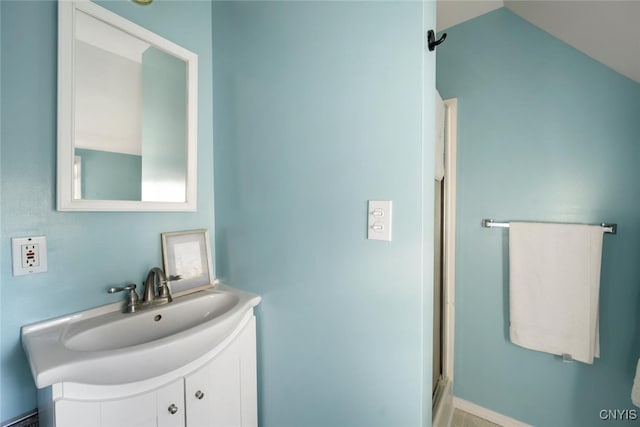 bathroom with vanity, an enclosed shower, and lofted ceiling